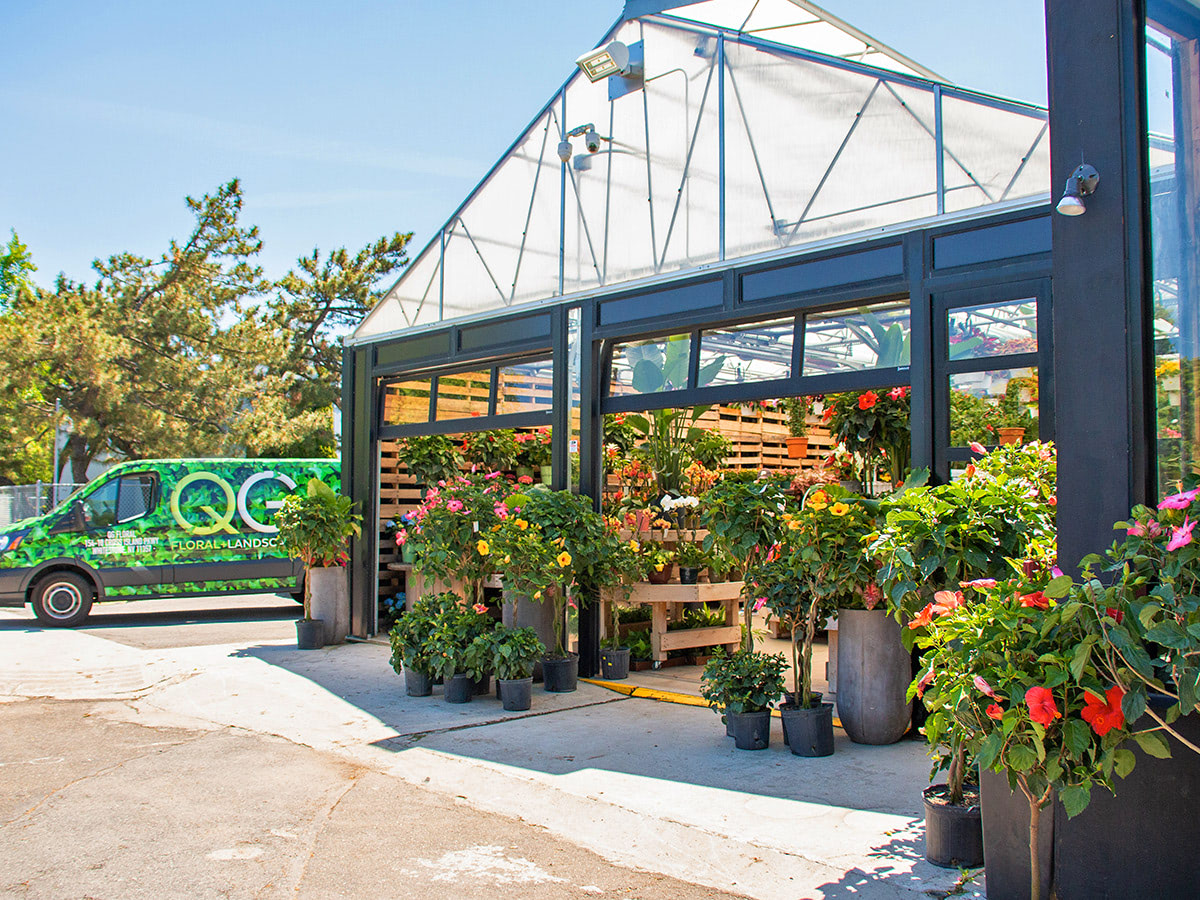 A QG Floral + Landscape van parks just outside the open garage doors of our greenhouse